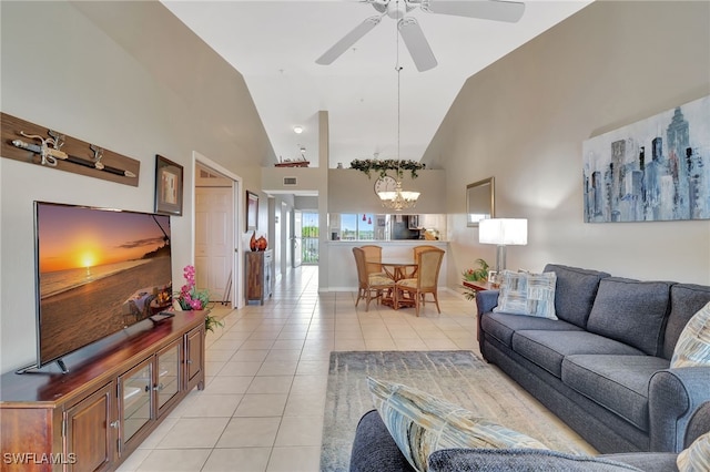 living area featuring high vaulted ceiling, light tile patterned floors, visible vents, and ceiling fan with notable chandelier