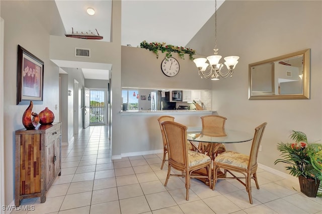 dining space with high vaulted ceiling, visible vents, an inviting chandelier, and light tile patterned flooring