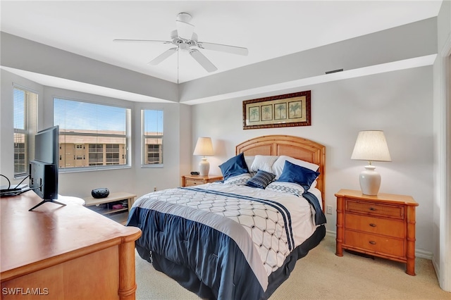 bedroom featuring light colored carpet and a ceiling fan