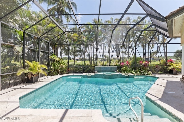 view of pool with a patio area, a pool with connected hot tub, and glass enclosure