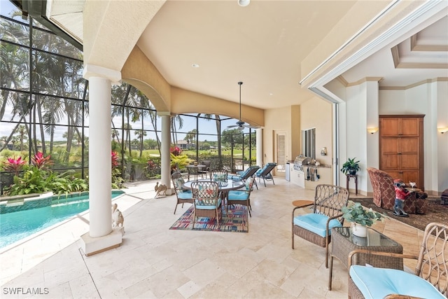 exterior space with a lanai, area for grilling, outdoor dining space, and a pool with connected hot tub