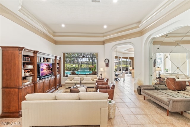living area featuring recessed lighting, light tile patterned floors, crown molding, a tray ceiling, and arched walkways