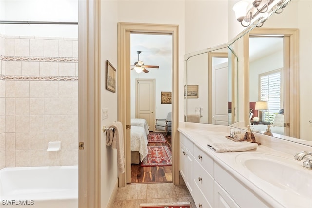 full bath featuring washtub / shower combination, vanity, tile patterned flooring, ensuite bath, and a ceiling fan