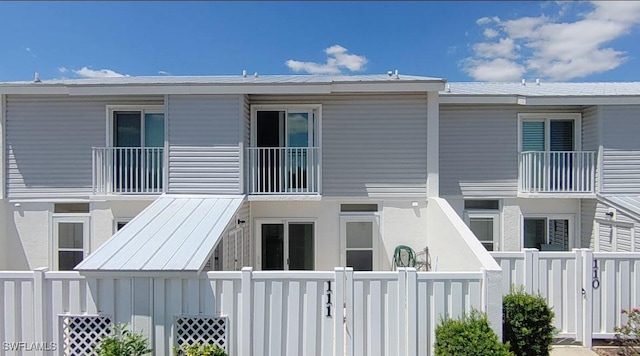 rear view of property featuring fence