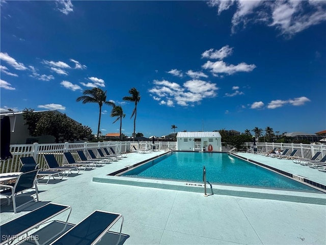 pool with fence and a patio