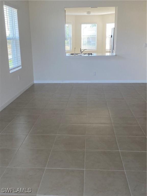 211 NE 20th St, Cape Coral, FL 33909 - tiled empty room with baseboards