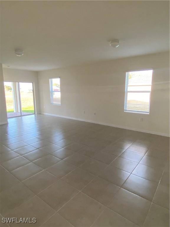 211 NE 20th St, Cape Coral, FL 33909 - tiled spare room with baseboards