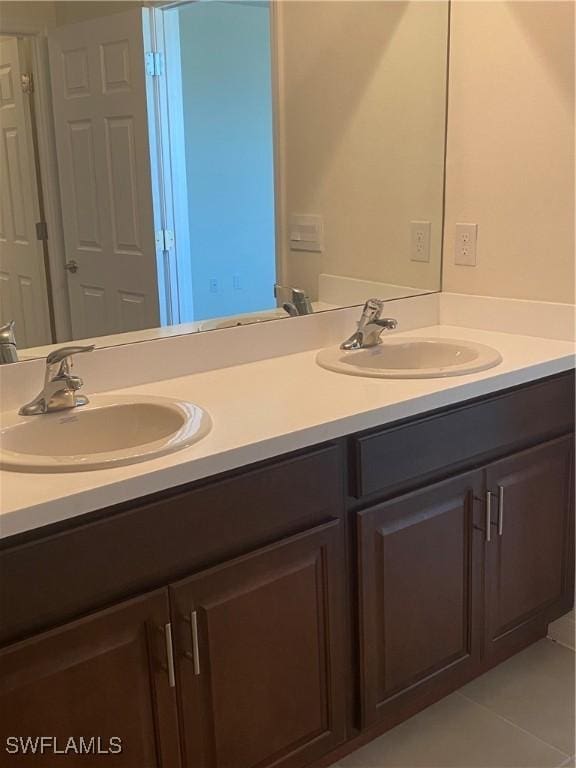 211 NE 20th St, Cape Coral, FL 33909 - full bathroom featuring a sink, double vanity, and tile patterned flooring