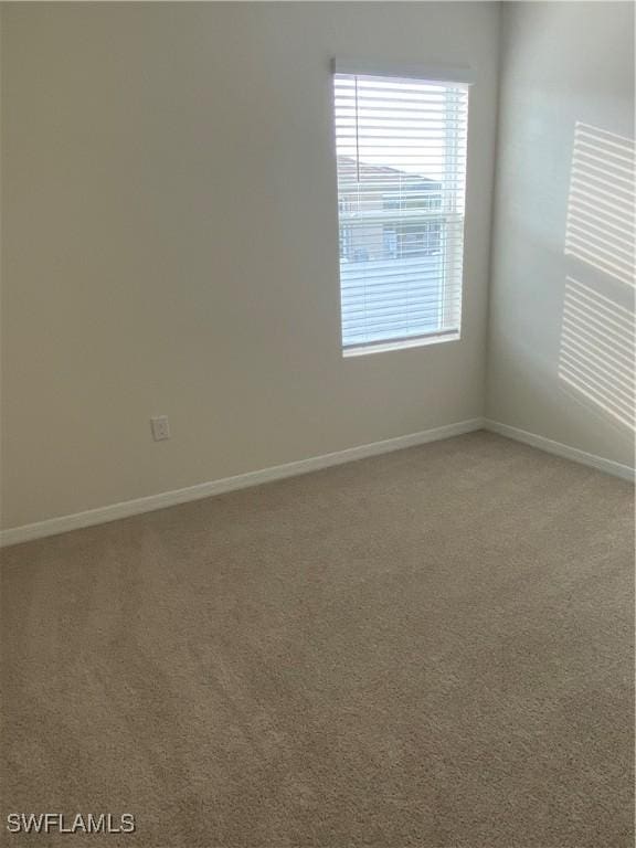 211 NE 20th St, Cape Coral, FL 33909 - carpeted empty room with baseboards