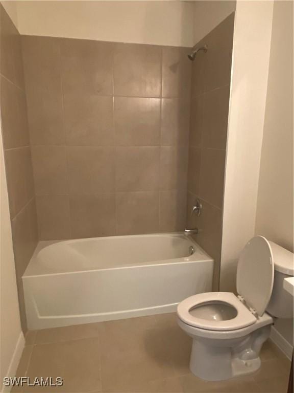 211 NE 20th St, Cape Coral, FL 33909 - full bath featuring toilet, baseboards, tile patterned flooring, and shower / washtub combination