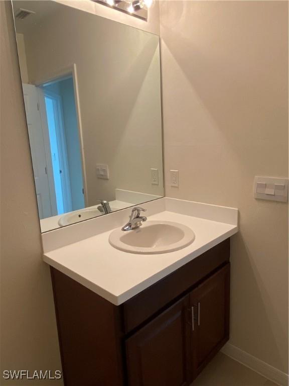 211 NE 20th St, Cape Coral, FL 33909 - bathroom featuring vanity, baseboards, and visible vents