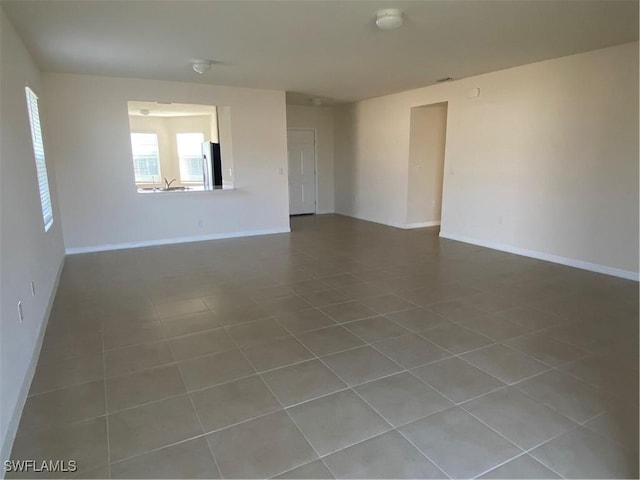 211 NE 20th St, Cape Coral, FL 33909 - unfurnished room with tile patterned floors and baseboards