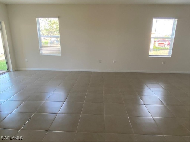 211 NE 20th St, Cape Coral, FL 33909 - tiled empty room with a wealth of natural light and baseboards