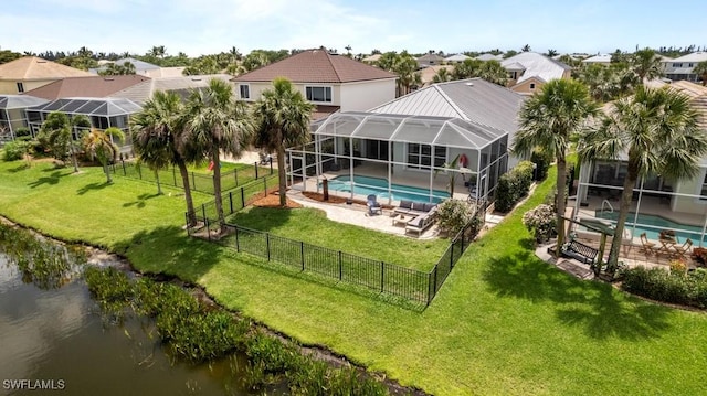 back of property featuring a patio, a water view, a residential view, and a lanai