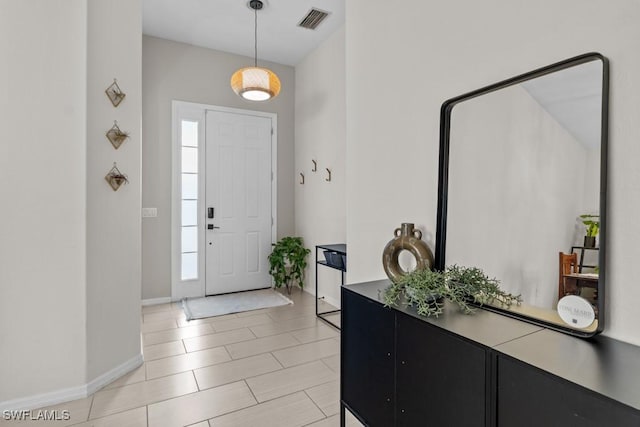 entrance foyer featuring baseboards and light tile patterned floors