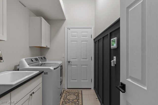 laundry area with washing machine and dryer and cabinet space