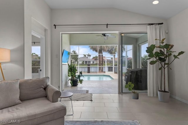 living area featuring ceiling fan and vaulted ceiling