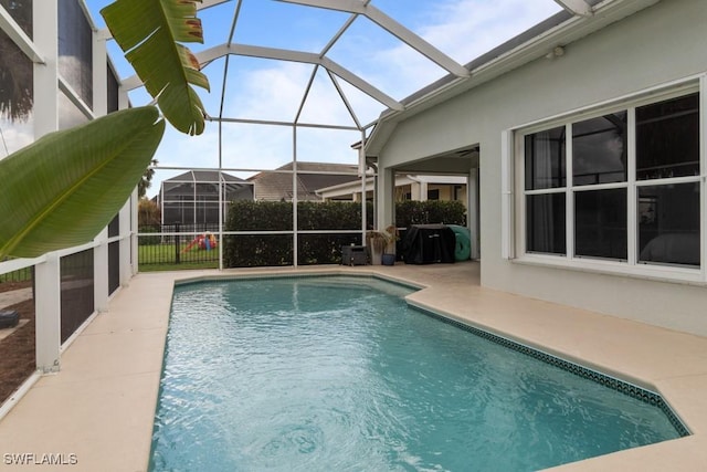 view of pool featuring a patio area and glass enclosure