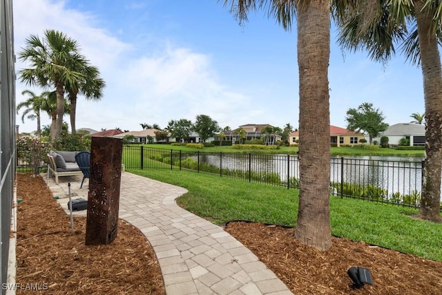 view of property's community featuring a water view, a patio area, and a residential view