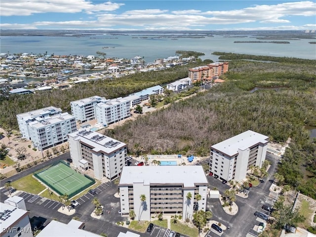 bird's eye view of apartment complex and a nearby body of water