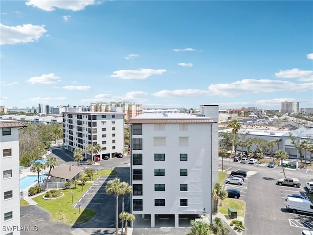 view of property with a view of city and uncovered parking