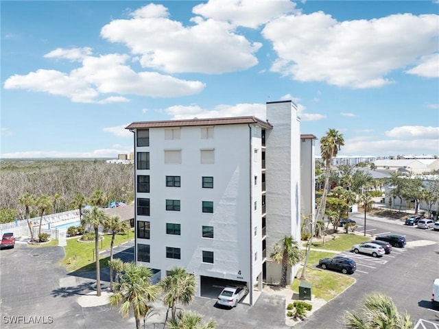view of building exterior featuring uncovered parking