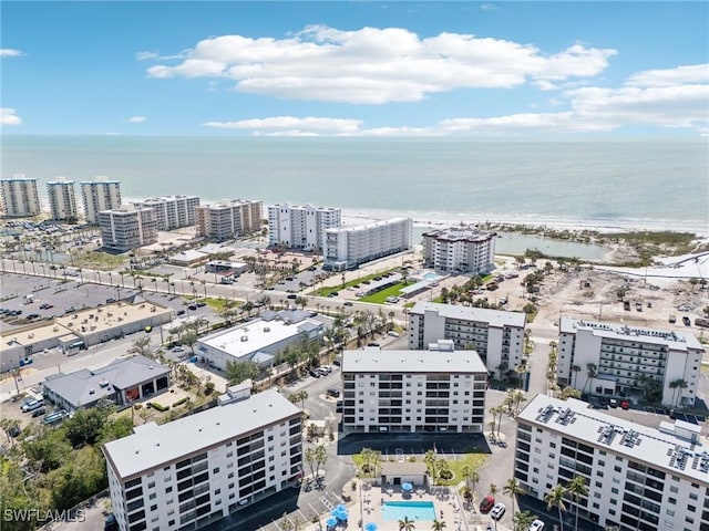 view of urban area featuring a nearby body of water and a pool