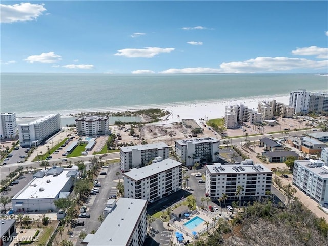 view of urban area with a nearby body of water and a pool area