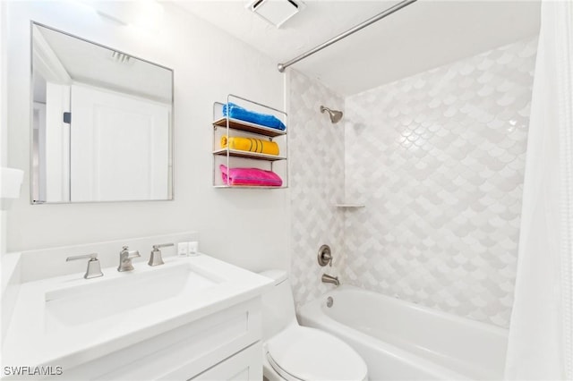 bathroom featuring toilet, shower / bath combo with shower curtain, and vanity