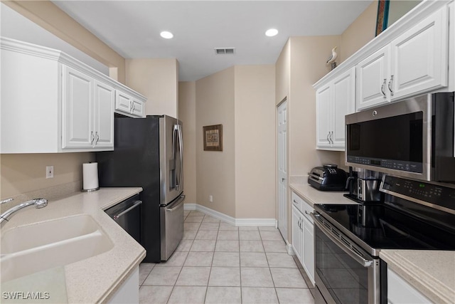 kitchen with white cabinetry, visible vents, light countertops, a sink, and stainless steel appliances