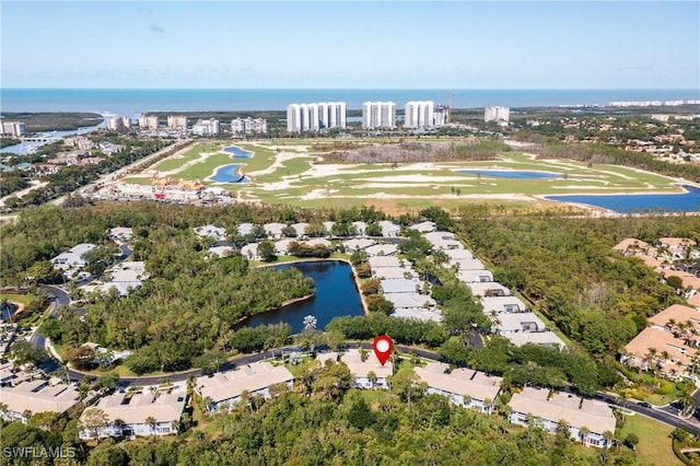 birds eye view of property with a water view, a residential view, and view of golf course