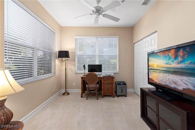 office space featuring light carpet, ceiling fan, baseboards, and visible vents