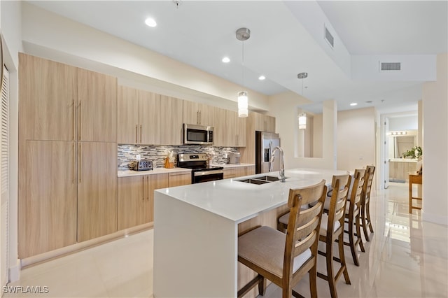 15901 Royal Pointe Ln Unit 404, Fort Myers, FL 33908 - kitchen featuring light brown cabinets, a sink, modern cabinets, and stainless steel appliances