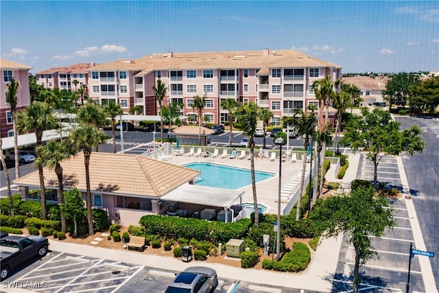 15901 Royal Pointe Ln Unit 404, Fort Myers, FL 33908 - view of property featuring a community pool and uncovered parking