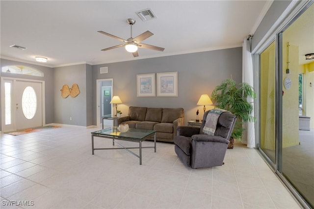 living area featuring a ceiling fan, ornamental molding, and visible vents