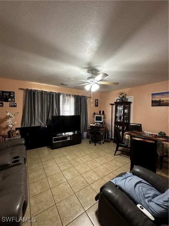 110 Clayton Ave, Lehigh Acres, FL 33936 - living area with a textured ceiling, light tile patterned floors, and a ceiling fan