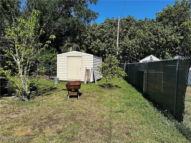 110 Clayton Ave, Lehigh Acres, FL 33936 - view of yard featuring an outbuilding, a fenced backyard, and a storage unit
