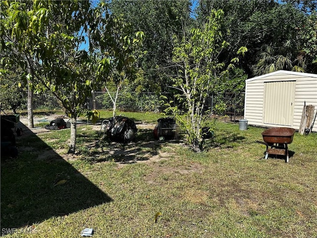 110 Clayton Ave, Lehigh Acres, FL 33936 - view of yard featuring a storage shed, an outdoor structure, and fence