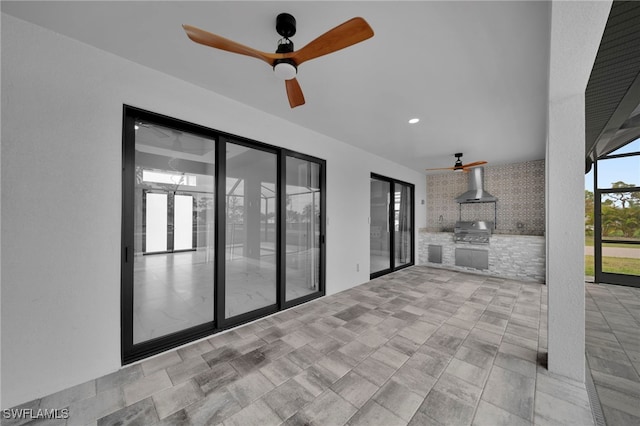 view of patio / terrace with a lanai, area for grilling, an outdoor kitchen, and a ceiling fan