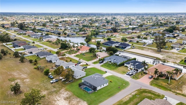 bird's eye view featuring a residential view and a water view