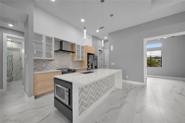 kitchen with marble finish floor, wall chimney exhaust hood, stainless steel appliances, and modern cabinets