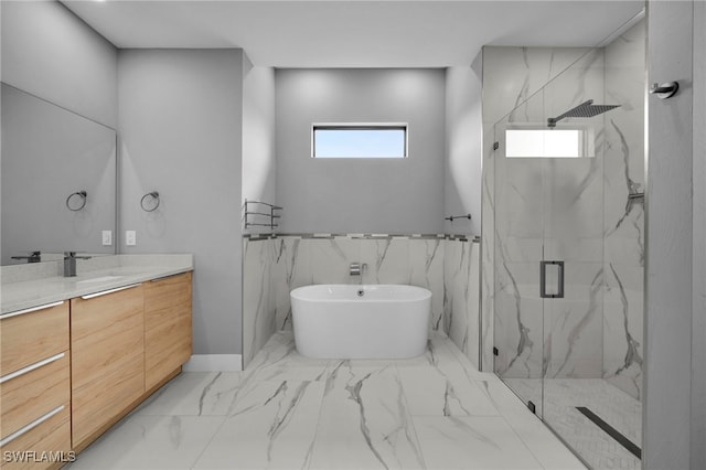 bathroom featuring a marble finish shower, a freestanding bath, marble finish floor, and vanity