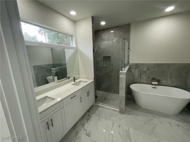 full bath with marble finish floor, a sink, a marble finish shower, and a soaking tub