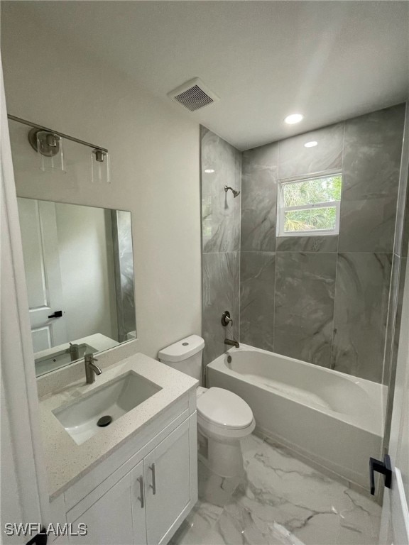 bathroom featuring visible vents, toilet, vanity, shower / bathtub combination, and marble finish floor