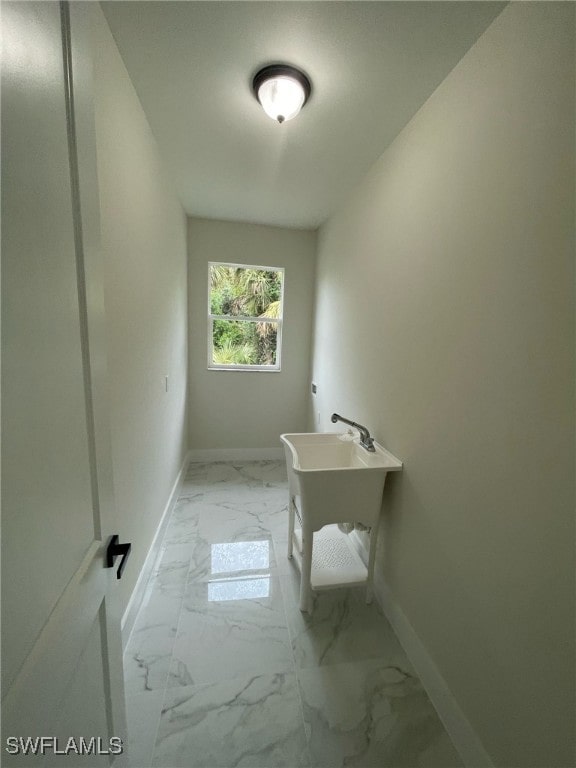 bathroom featuring baseboards and marble finish floor