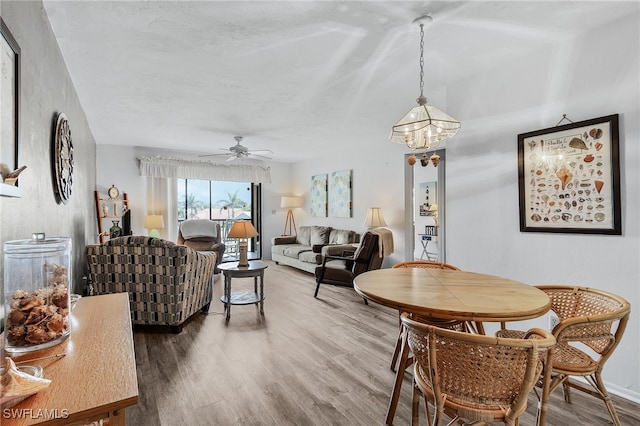 11170 Caravel Cir Unit 210, Fort Myers, FL 33908 - dining room featuring ceiling fan with notable chandelier and wood finished floors