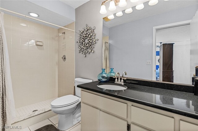 11170 Caravel Cir Unit 210, Fort Myers, FL 33908 - bathroom featuring tile patterned flooring, a shower stall, toilet, and vanity