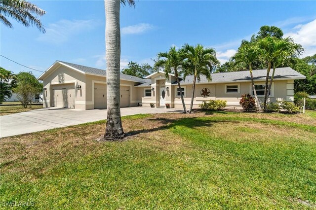 single story home with an attached garage, a front lawn, stucco siding, and concrete driveway