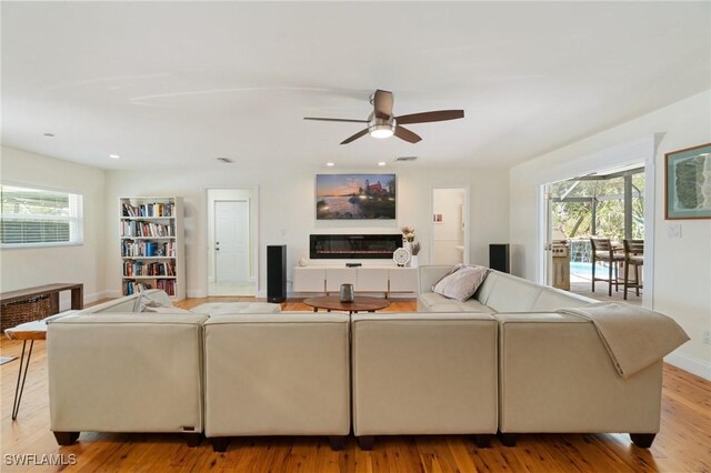 living area with plenty of natural light, a ceiling fan, wood finished floors, and recessed lighting