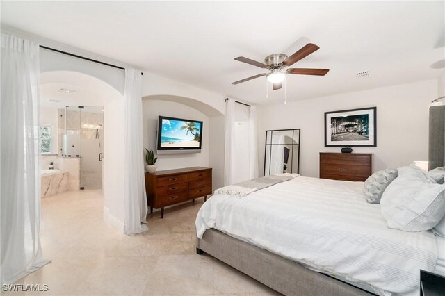 bedroom featuring visible vents, arched walkways, a ceiling fan, and ensuite bath